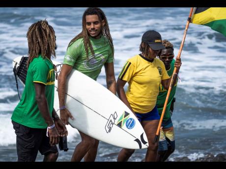 Jamaica’s Elishama Beckford (second left) speaks to his teammates Icah Wilmot (left), Imani Wilmot (second right) and Javaun Brown after competing in the opening round on yesterday’s day two of the International Surfing Association’s World Surfing Ga