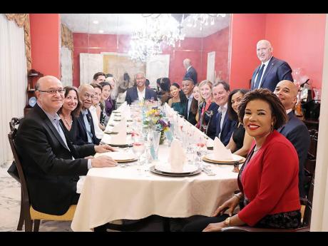 Jamaica’s Ambassador to the United States Audrey Marks (front right) hosts a dinner in honour of Jamaican academic Dr. Peter Blair Henry (head of the table) on his recent appointment to the faculty of Stanford University. Also seated at the table are Pre