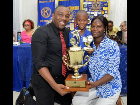 Zayne Thomas (centre), celebrates his win with his parents Damion Thomas (left) and Shanika Brown.