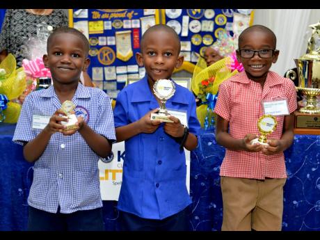 The top three spellers (from left): Amare Green of Jamaica House Basic School who finished third; winner Zayne Thomas and second-place finisher Emmanuel Hunter from Amy Bailey Basic School, show their trophies.
