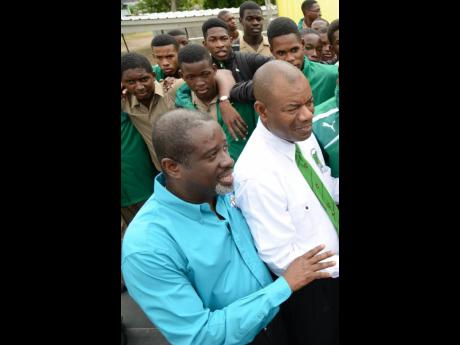 Chairman of the Board of Management of Calabar High School Rev. Karl Johnson (left) and  Principal of Calabar High Albert Corcho (right) at the school’s celebration ceremony after their victory at the ISSA-GraceKennedy Boys and Girls’ Athletics Champio