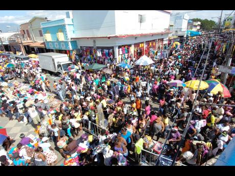 This file photo shows shoppers in downtown Kingston. Imani Tafari-Ama writes: If this fiscal improvement looks so rosy on politicians’ pay cheques, does that suggest a trickle-down effect for the rest of the population? 