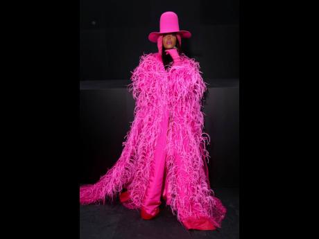 Erykah Badu poses for photographers upon arrival at the Valentino ready-to-wear Spring/Summer 2023 fashion collection presented in Paris on October 2, 2022.  The four-time Grammy winner released a 42-piece capsule collection with Italian fashion house Marn