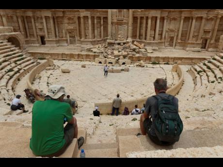 Tourists visit Roman ruins in Palmyra, Syria.