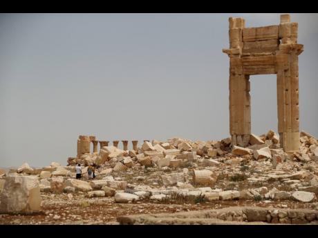 Tourists visit Roman ruins in Palmyra, Syria. Palmyra was captured by the Islamic State militants in 2015, who blew up some of the most iconic structures.