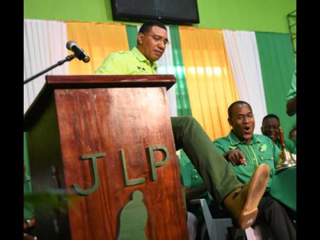
St Andrew North Western Member of Parliament Nigel Clarke is animated as JLP leader Andrew Holness shows off his green Clarks at an Area Council One meeting at the Olympic Gardens Civic Centre in 2020.