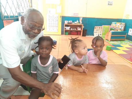 Pastor Rennard White checks on the church’s dozens of students at the early childhood institution daily