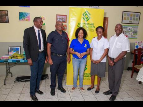 (From left) Dilton Pike and Howard Thomas, assistant superintendents of the Jamaica Fire Brigade; Heather Goldson, director of the Supreme Ventures Foundation (SVF); and Karen and Keith Haughton, administrators of the Nest Children’s Home, pose for a pho