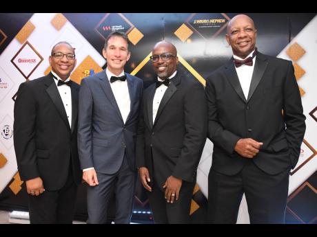  Flow representatives (from left): Charles Douglas, senior manager of government and regulatory affairs; Bruno Delhaise, senior director for B2C; Orville Lewis, senior manager of financial planning and analysis; and Pete Smith, region regulatory and financ
