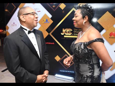 Charles Douglas, senior manager of government and regulatory affairs at Flow, engages in conversation with Senior Superintendent of Police Stephanie Lindsay.