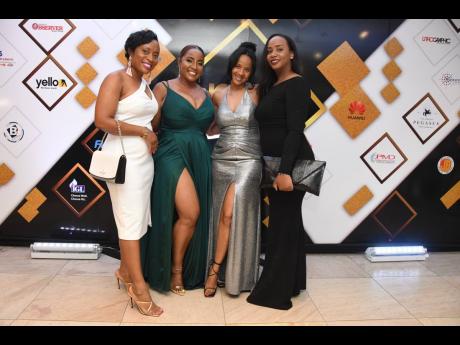 Supreme Ventures Limited’s company secretary, Dionne Reid, strikes a pose with colleagues, Shauna Isaacs, financial controller of treasury; Stephanie Eubanks, assistant vice-president, regulatory and operational compliance; and  vice-president of legal, 
