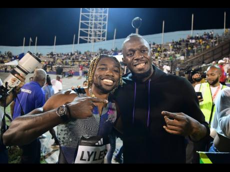 Winner of the Racers Grand Prix men’s 200 metres, American Noah Lyles (left), with world record holder Usain Bolt at the National Stadium on Saturday night. Noah clocked a meet record 19.67 seconds. 