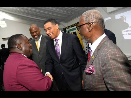 Prime Minister Andrew Holness (second right) greets (from left) Hubert Williams, mayor of Morant Bay; Dr Wayne Henry, director general of the Planning Institute of Jamaica; and Desmond McKenzie, minister of local government and community fevelopment and de