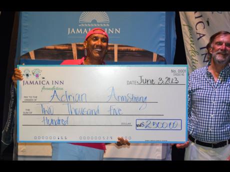 Adrian Armstrong (left) beams as he accepts his US$2,500 first-prize cheque from Eric Morrow, Chairman, Jamaica Inn Foundation, at Saturday night’s awards ceremony of the Sixth Annual Jamaica Inn Backgammon Open.
