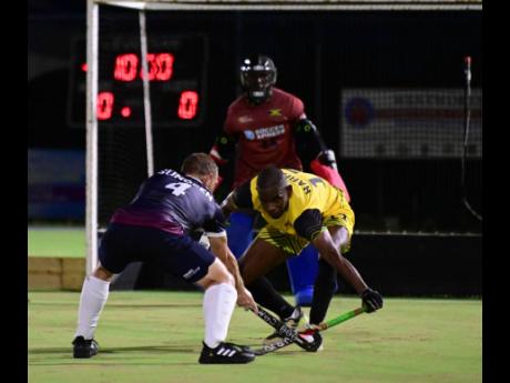 Tyler Sundeen (left) of the United States in a tussle with Jamaica’s Richard Harris during the  2023 Hockey5’s Pan American Cup match held at the Mona Hockey Field yesterday. The United States won 4-2.