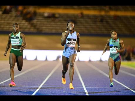 Shericka Jackson (centre) wins the women’s 100 metres A final in a meet record 10.78 seconds at the Racers Grand Prix last Saturday.  Anthonique Strachan (left) of the Bahamas was second in a season’s best 10.99 while American Celera Barnes (right) was