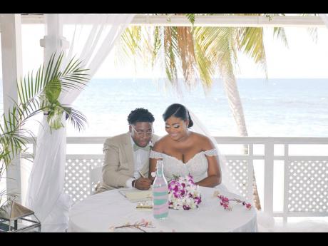 In the midst of the swaying palm trees, the picturesque ocean and island breeze, Nicholi and Latara sign their marriage certificate.