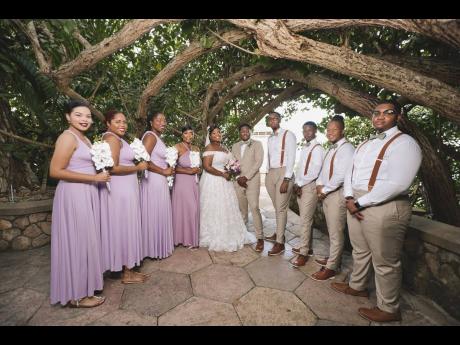 Nicholi and Latara (centre) were grateful for the support from their lovely bridal party. From left: bridesmaids Allison Mullings; Jody-Ann Lawrence; Kadeja Spencer; maid of honour Tamieka Boodie; best man Raheem Blackwood and groomsmen Brandon Bailey, Cla