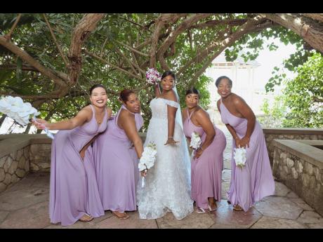 The centre of attention in her stunning wedding dress, the happy bride (centre) is joined by her excited bridesmaids (from left) Allison Mullings, Jody-Ann Lawrence, (maid of honour) Tamieka Boodie and Kadeja Spencer. 