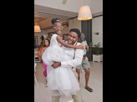 Latara’s niece and flower girl, Rue Davy, shares a priceless moment with her Uncle Nicholi. 