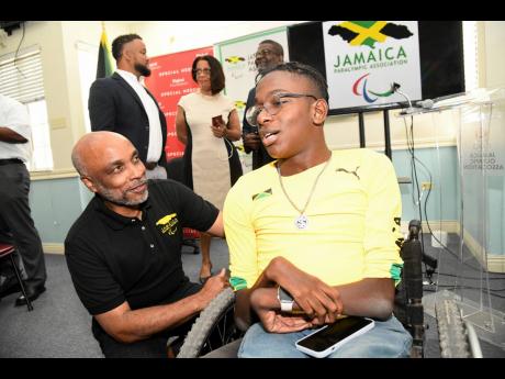 Christopher Samuda (left), Jamaica Paralympic Association president, with athlete Nathaniel Bailey at the I’m Phenomenal and Paralympic Day press briefing at the Jamaica Olympic Association head office on Tuesday, February 28, 2023.