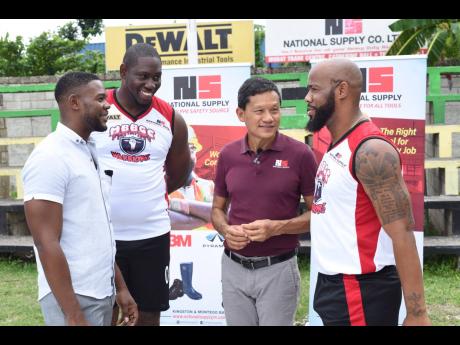 Coach/Player of the Montego Bay Boys and Girls Club basketball team, Warriors, Levar Rose (right) has the attention of (from left) Chairman of the Montego Bay Boys and Girls Club Board, Richard Vernon, player Joel Smith and Donovan Chen See, Director of Na