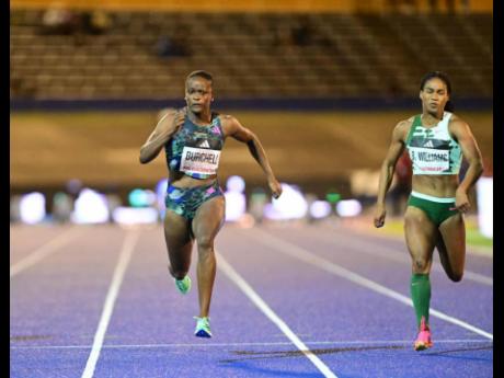 Remona Burchell (left) and the fast-starting Briana Williams race during the 100-metre ‘B’ final at the Racers’ Grand Prix this evening at the National Stadium. 