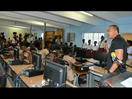 Minister of Health and Wellness Dr Christopher Tufton speaks with students at Denham Town High School in Kingston yesterday on ways to combat mental health issues. Tufton was speaking with students during yesterday’s leg of a mental health intervention p