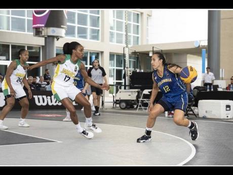 Jamaica’s Morgan Green (left) guards a Colombian player during a FIBA 3x3 AmeriCup basketball tournament last year.