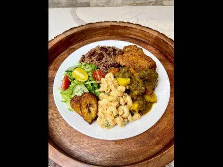 ABOVE: Here’s a food medley that anyone would be delighted to savour: fried chicken, curried goat, rice and peas, macaroni salad, fried ripe plantain and garden salad.
