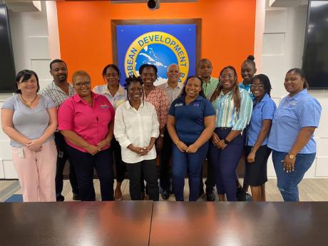 Participants in CDB’s Basic Needs Trust Fund’s (BNTF) four-day regional gender training workshop, held recently in Barbados, with Dr Maria Ziegler (left), gender specialist at the CDB, and George Yearwood (back row, centre), portfolio manager at the BN