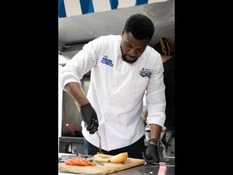 Chef André Sewell uses a blowtorch to lightly toast the bread on his fried chicken sandwich.