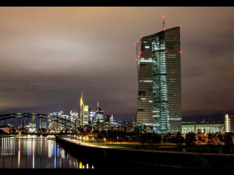 AP 
The European Central Bank stands next to the buildings in the banking district in Frankfurt, Germany.