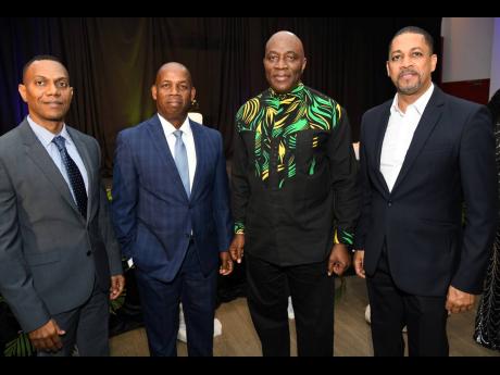 Chief Justice Bryan Sykes (second right), guest speaker at the event, with (from left) Andre Goindoo, managing director and CEO of CUNA Caribbean Insurance Society Limited; Lambert Johnson, president of Jamaica Co-operative Credit Union League (JCCUL); and