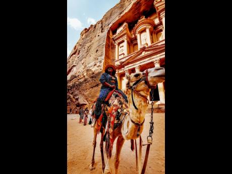 Seeing the wonders of the world, Anthony went camel riding in Petra, Jordan.