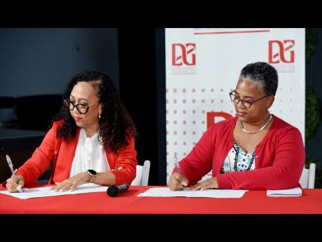 Dianne Ashton-Smith (left), head of corporate affairs, Red Stripe and Nadine Chambers-Goss (right), executive director, Rise Life Management Services, sign a $12 million partnership during Red Stripe’s ‘Responsibility Now’ town hall series: making se