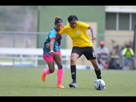 Cavalier’s Kadian Edwards (right) gets away from Davia Richards of Frazsiers Whip during the Jamaica Women’s Premier League KO final at the UWI-JFF Captain Horace Burrell Centre of Excellence on Saturday, May 13, 2023. 