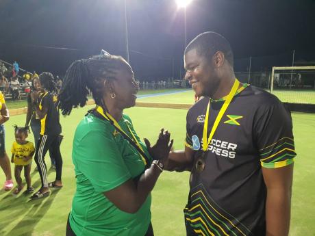 Jamaica Hockey Federation technical director, Michelle Holt, and men’s coach, Devaughn Henlon, greet each other after collecting third place medals at the Hockey 5s Pan American Cup at the Mona Hockey Field on Sunday.
Hubert Lawrence Photo