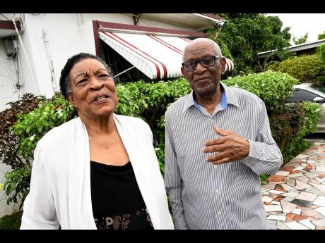 Norman Jarrett and wife Cecile take a walk in their yard at Valentine Drive