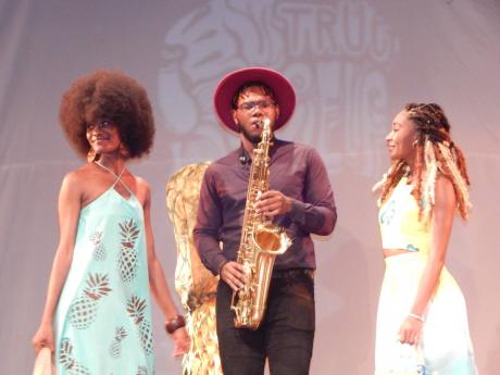 Saxophonist Deshaun Fender plays for models wearing clothes designed by Kehomi Thomas, part of the School of Visual Arts final-year opening ceremony.
