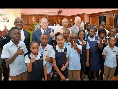 Back from left are: Custos of Manchester Garfield Green, Member or Parliament North East Manchester Audley Shaw, Minister of Education and Youth Fayval Williams, Minister of Justice Delroy Chuck, with the peace ambassadors from the Christiana High and Chri