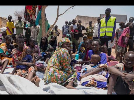 South Sudanese who fled from Sudan sit outside a nutrition clinic at a transit center in Renk, South Sudan, May 16. 
