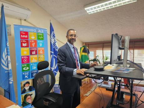 Stephen Rodriques, UNDP resident representative, proudly displays his Jamaican flag in his office in Kabul, Afghanistan