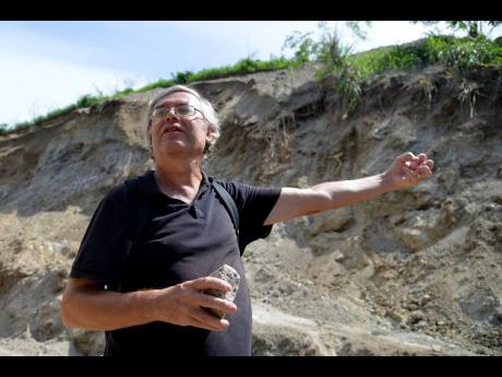 Professor Simon Mitchell, sedimentary geology and head of the Department of Geography and Geology at The University of the West Indies, examines the soil in the area where four new developments are raising concerns for residents in Jack’s Hill, St Andrew