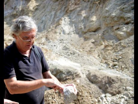 Professor Simon Mitchell examines the soil in the area where four new developments are raising concerns for residents in Jack’s Hill, St Andrew. 