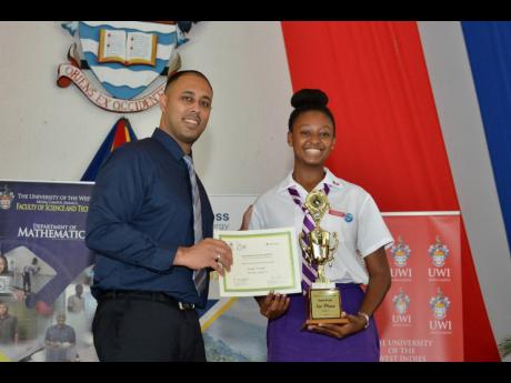 Jonathan Archie, deputy campus registrar in the Office of the Campus Registrar (OCR), presents the winning trophy and certificate to Kayla Wright, an 11th-grade student at Campion College. Wright placed first in the National Mathematical Olympiad, and was 