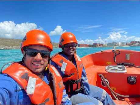 Danique Moore (background) with a colleague at sea.