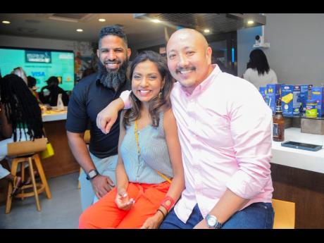 Jamaica Food and Drink Kitchen Managing Director Nicole Pandohie is flanked by Adam Jones (left) and Matthew Lyn, CB Group’s chief executive officer.