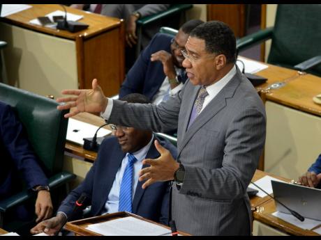 Prime Minister Andrew Holness making a presentation in Gordon House on Tuesday.