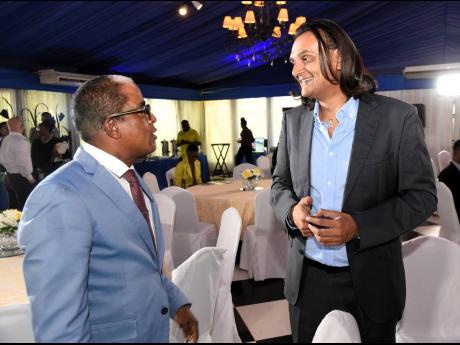 Ambassador Dushyant Savadia (right), founder and CEO, Amber Group, talks about unleashing the power of AI, Innovation and Investment to Dr Norman Dunn (left), minister of state in the Ministry of Labour and Social Security, during the World Productivity Da